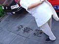 Picture of an artist, calligraphie with water taken in Peking